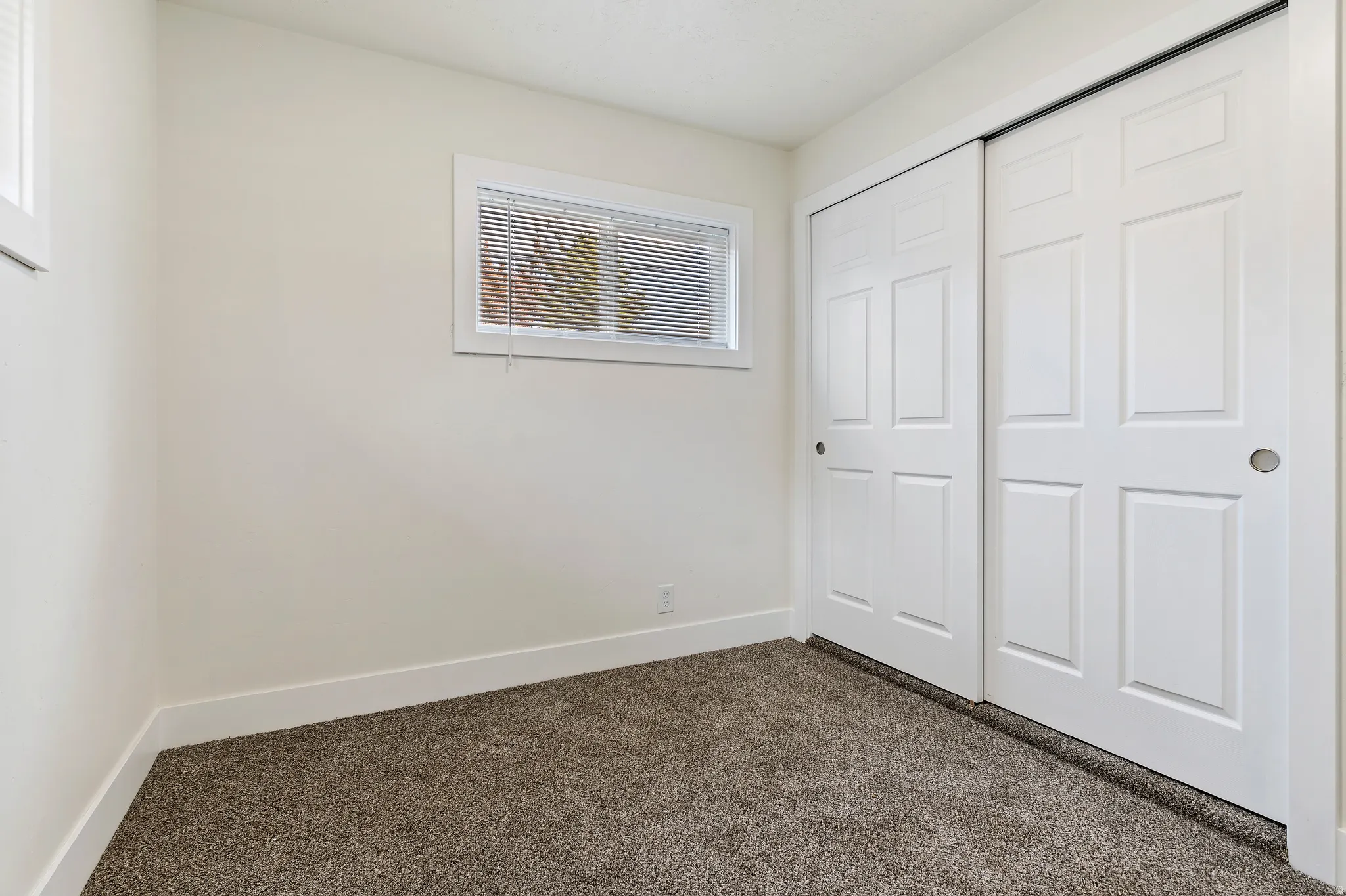Bedroom featuring dark colored carpet and a closet