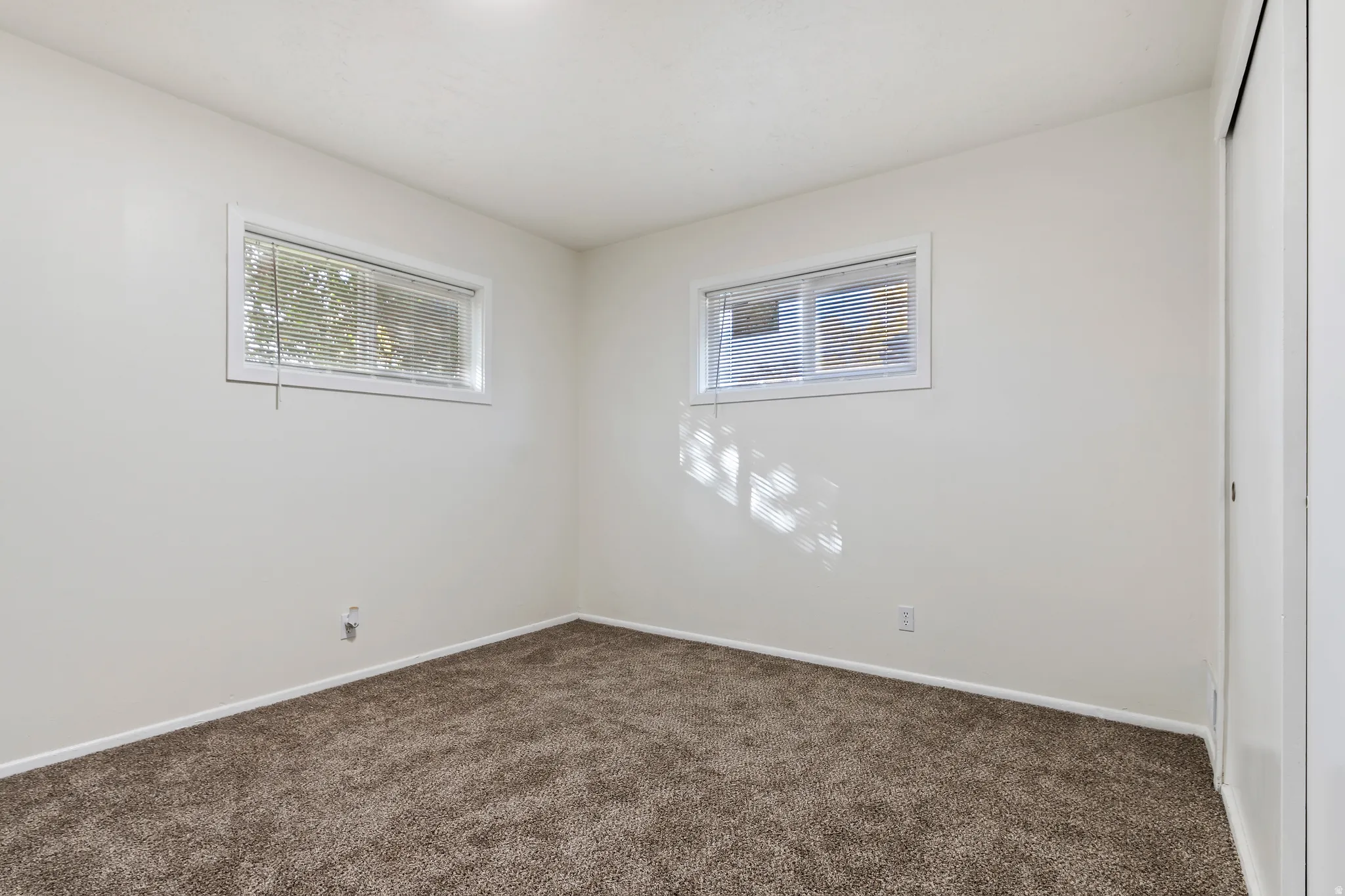 Bedroom with carpet floors and baseboards