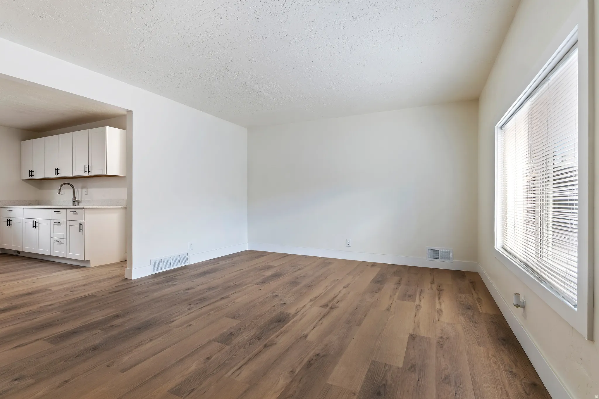 Unit 2 Living room with dark wood-style floors and a textured ceiling
