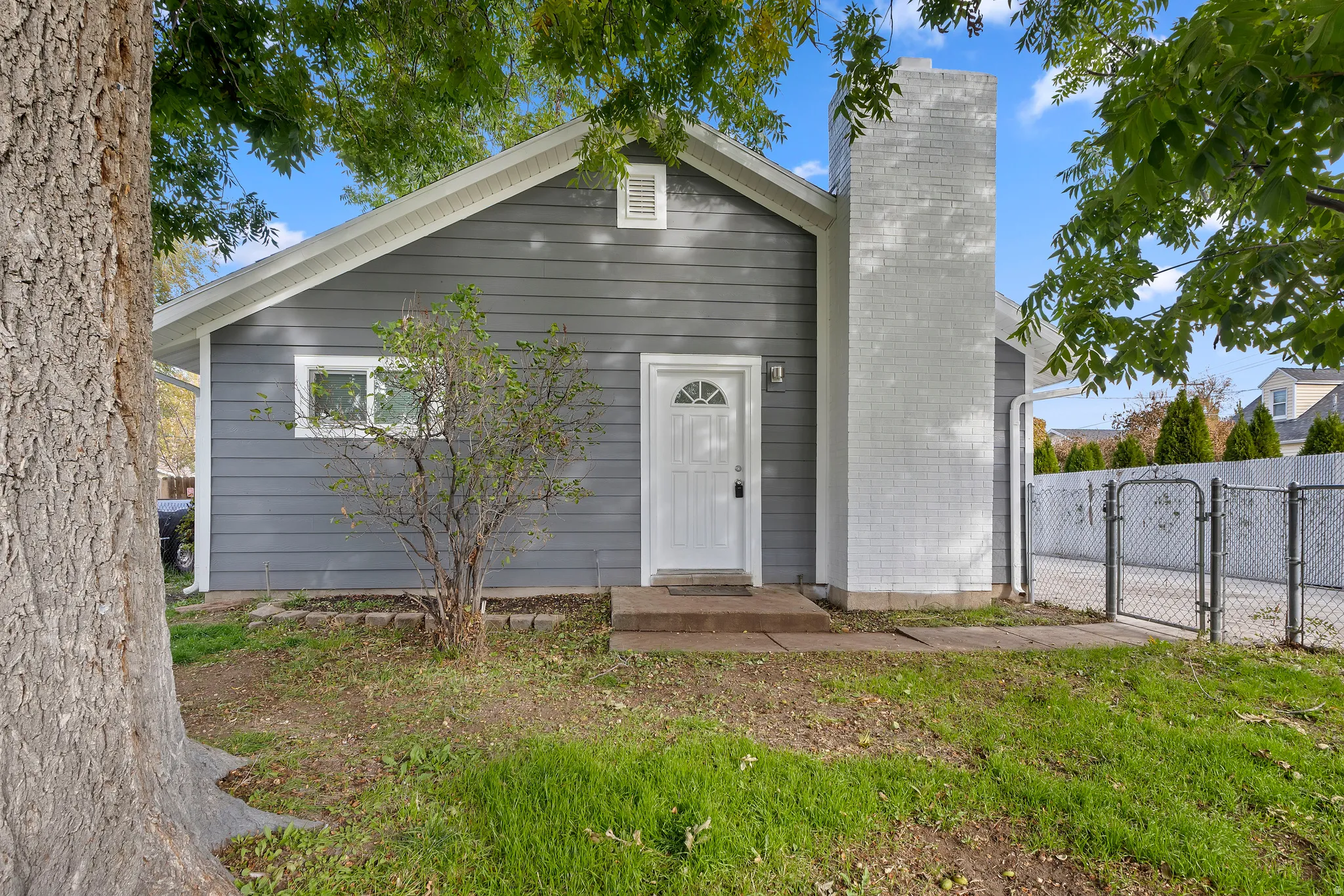 View of front of property featuring a gate and a chimney