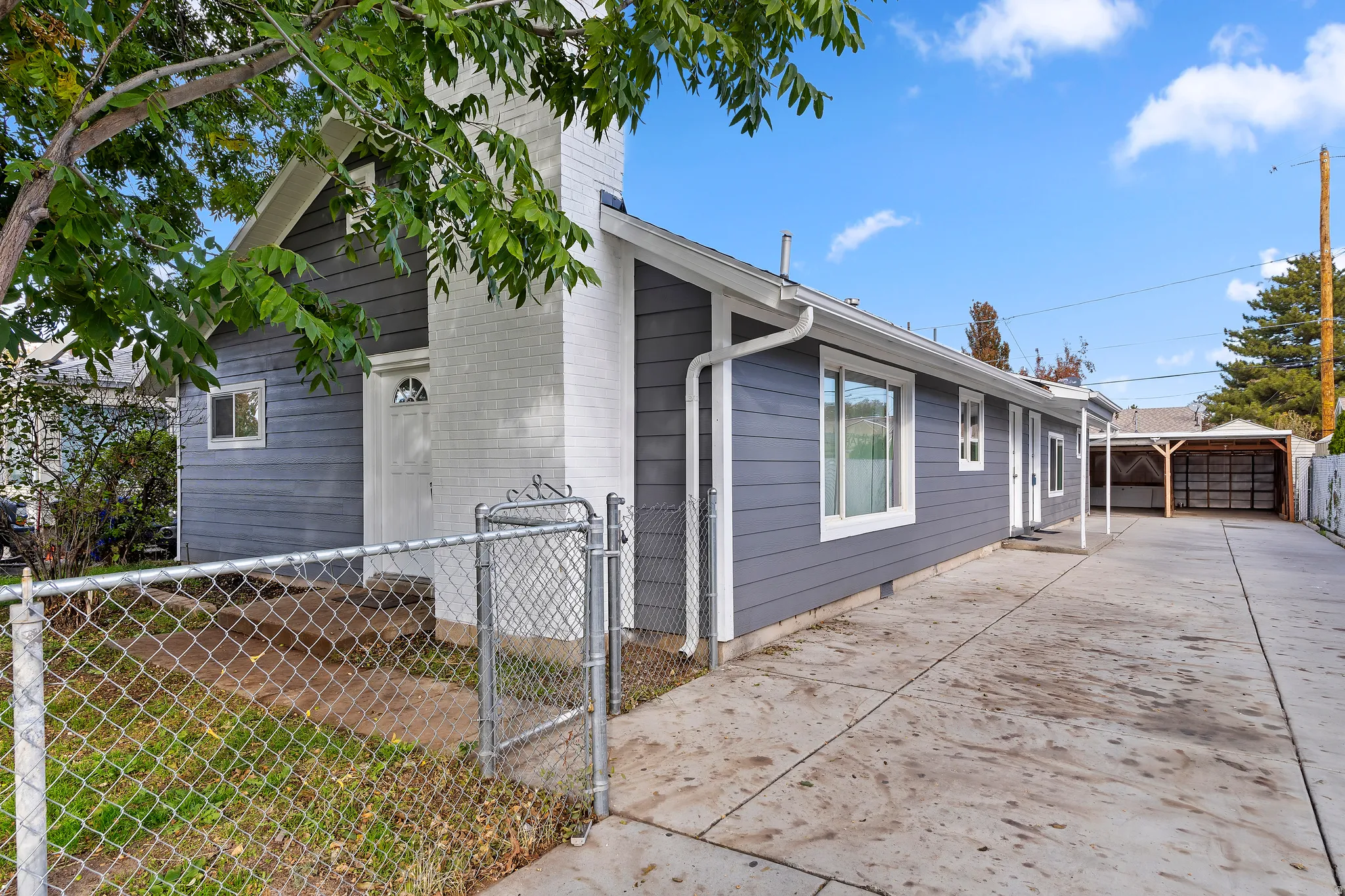View of property with a gate and carport