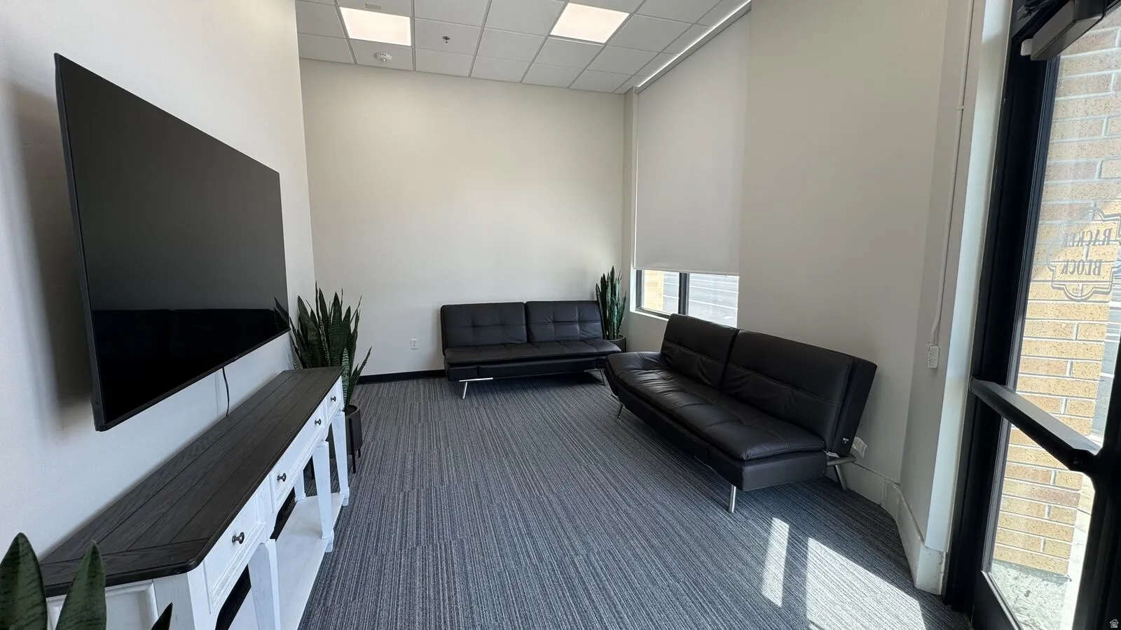 Sitting room featuring a paneled ceiling