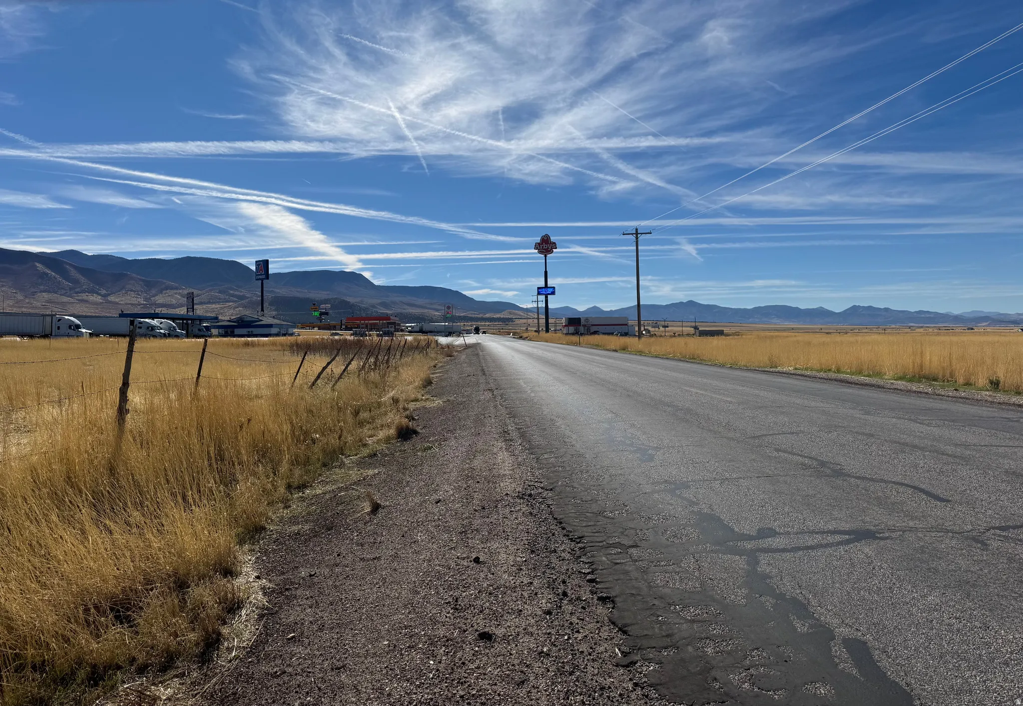 View of asphalt road with a mountain view and a view of countryside