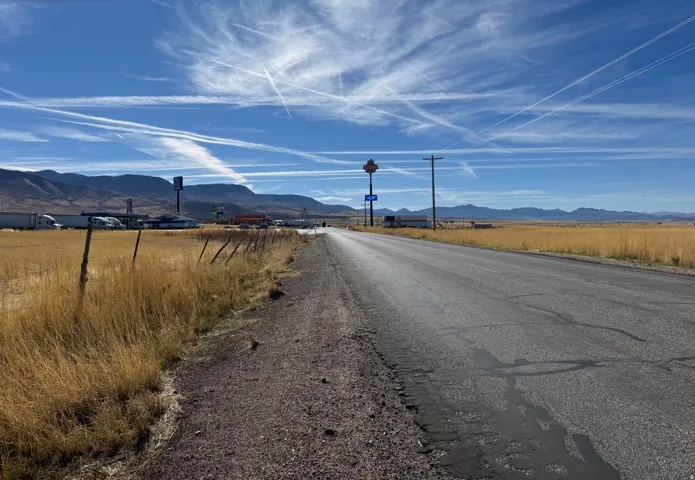 View of asphalt road with a mountain view and a view of countryside