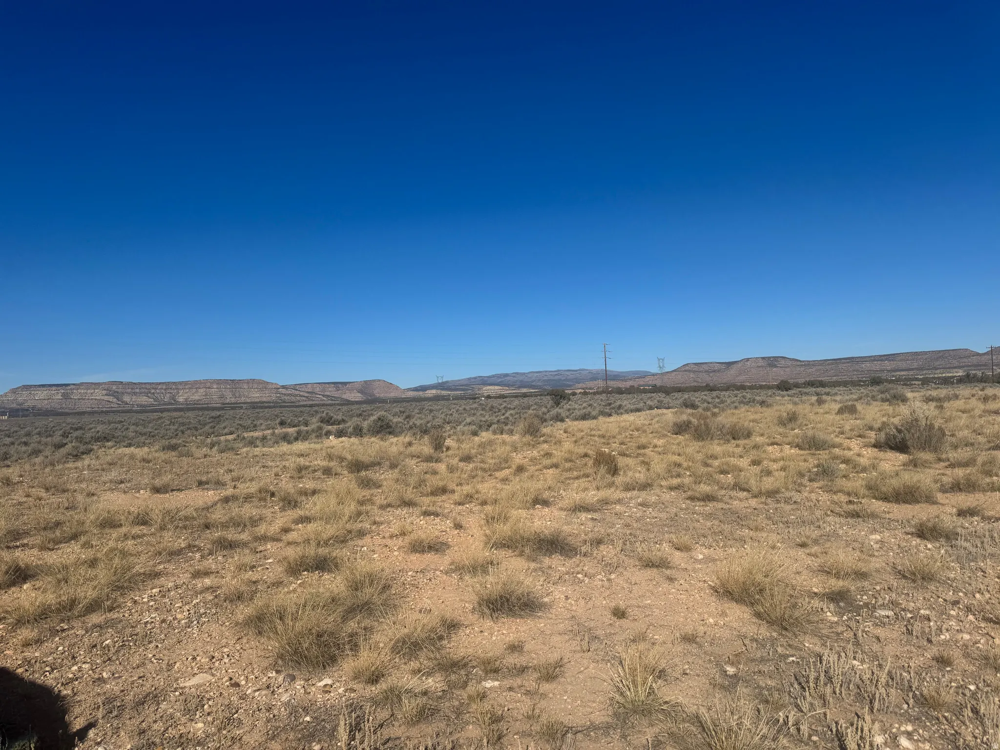 View of mountain backdrop with rural landscape and a desert landscape