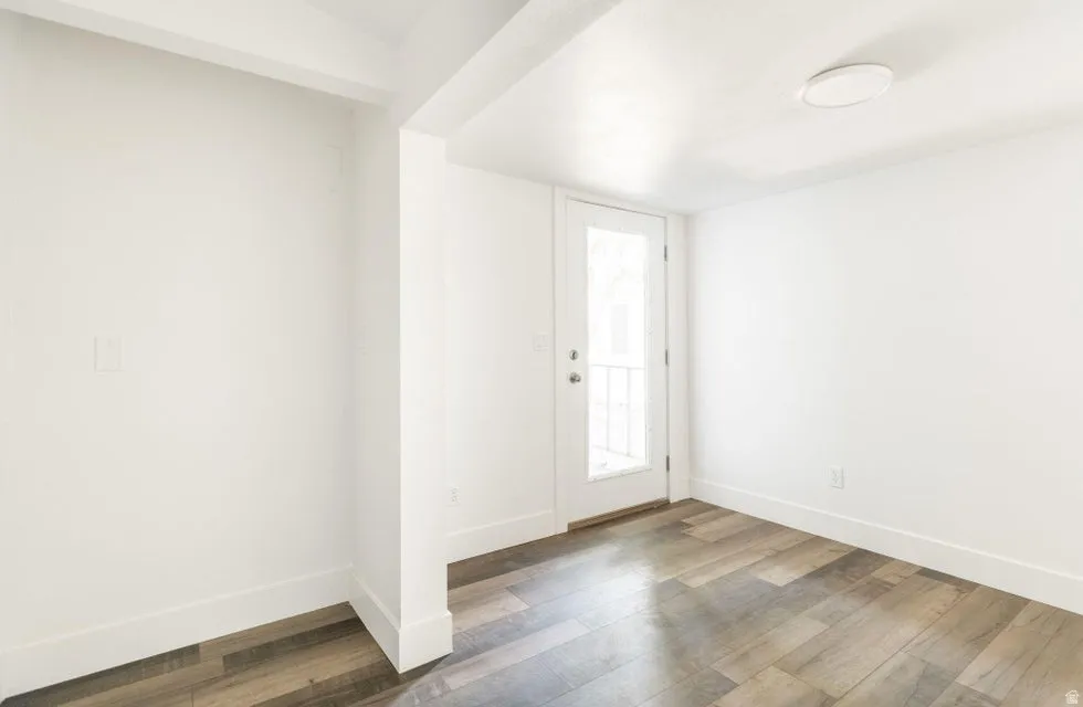 Entryway with baseboards and wood finished floors