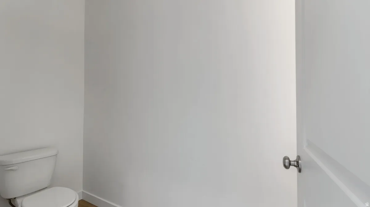 Half bath with toilet and baseboards