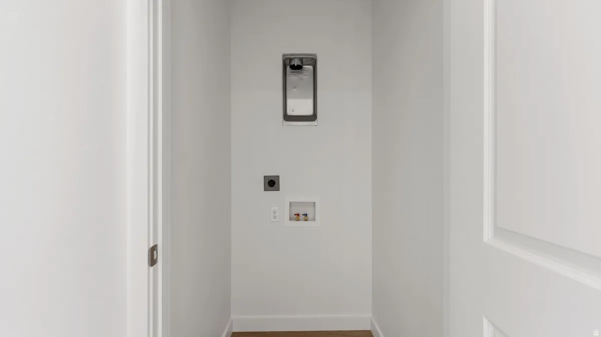 Laundry room featuring wood finished floors, hookup for an electric dryer, and hookup for a washing machine