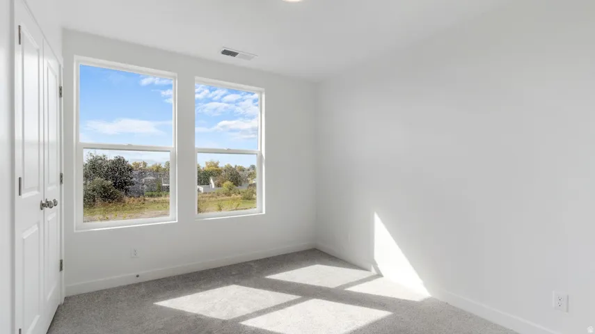 Unfurnished room featuring carpet
