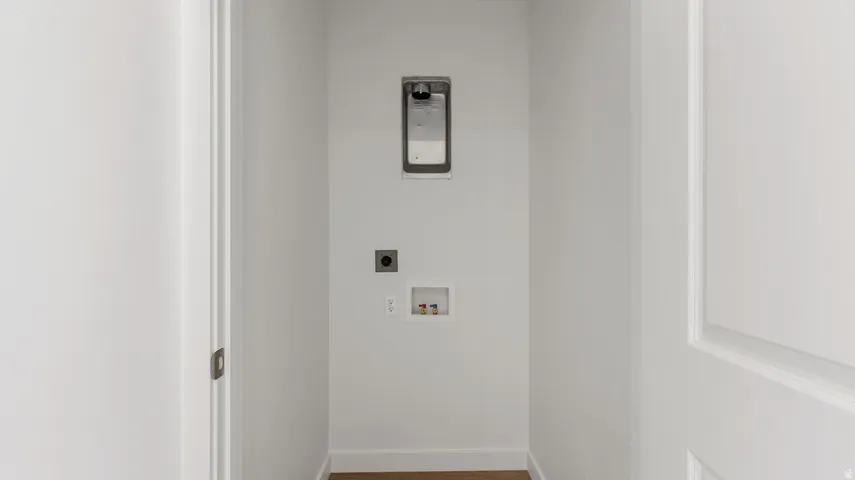 Laundry room featuring wood finished floors, hookup for an electric dryer, and hookup for a washing machine