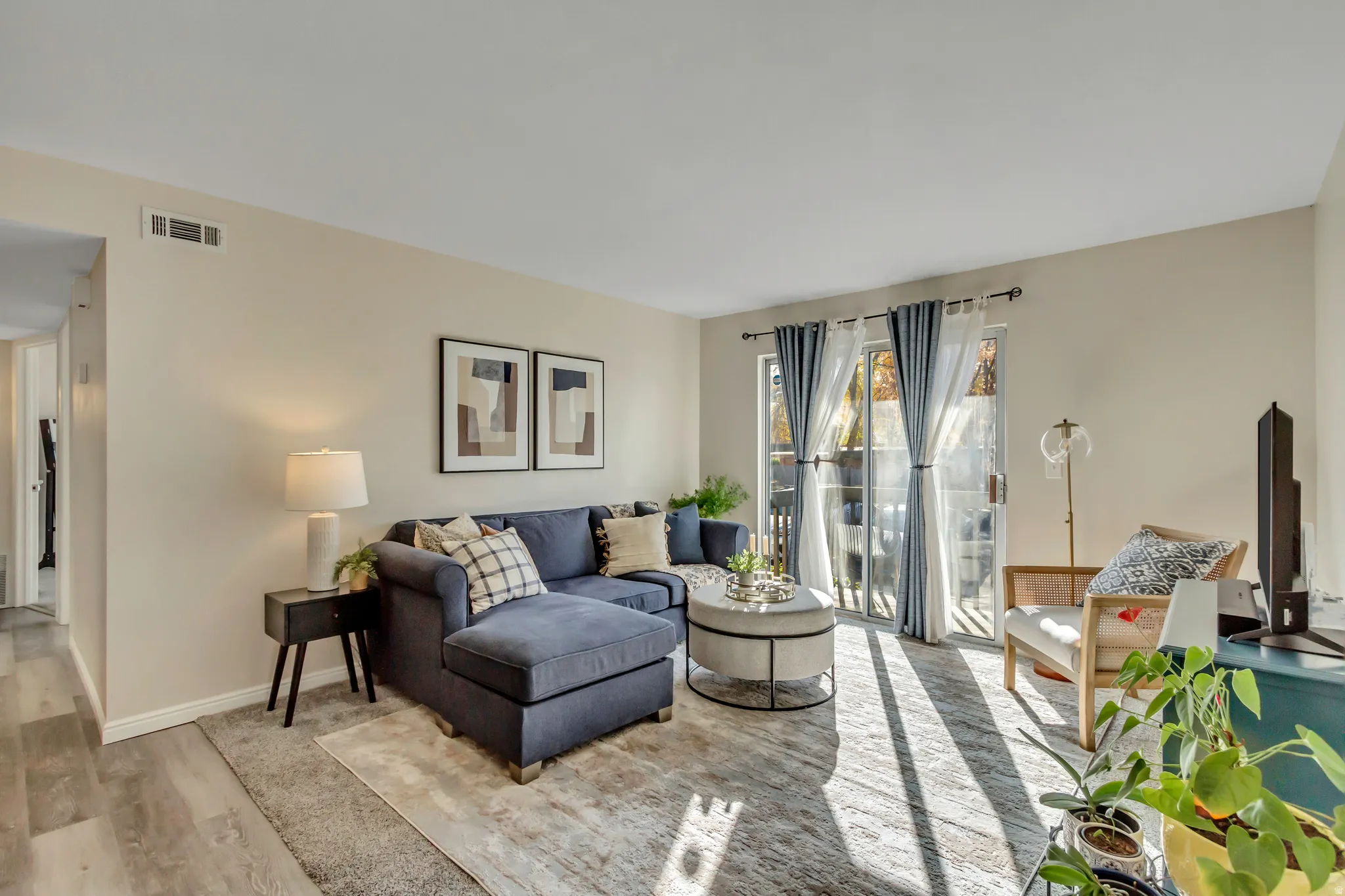 Living room/family room with sliding door that walks out to a balcony