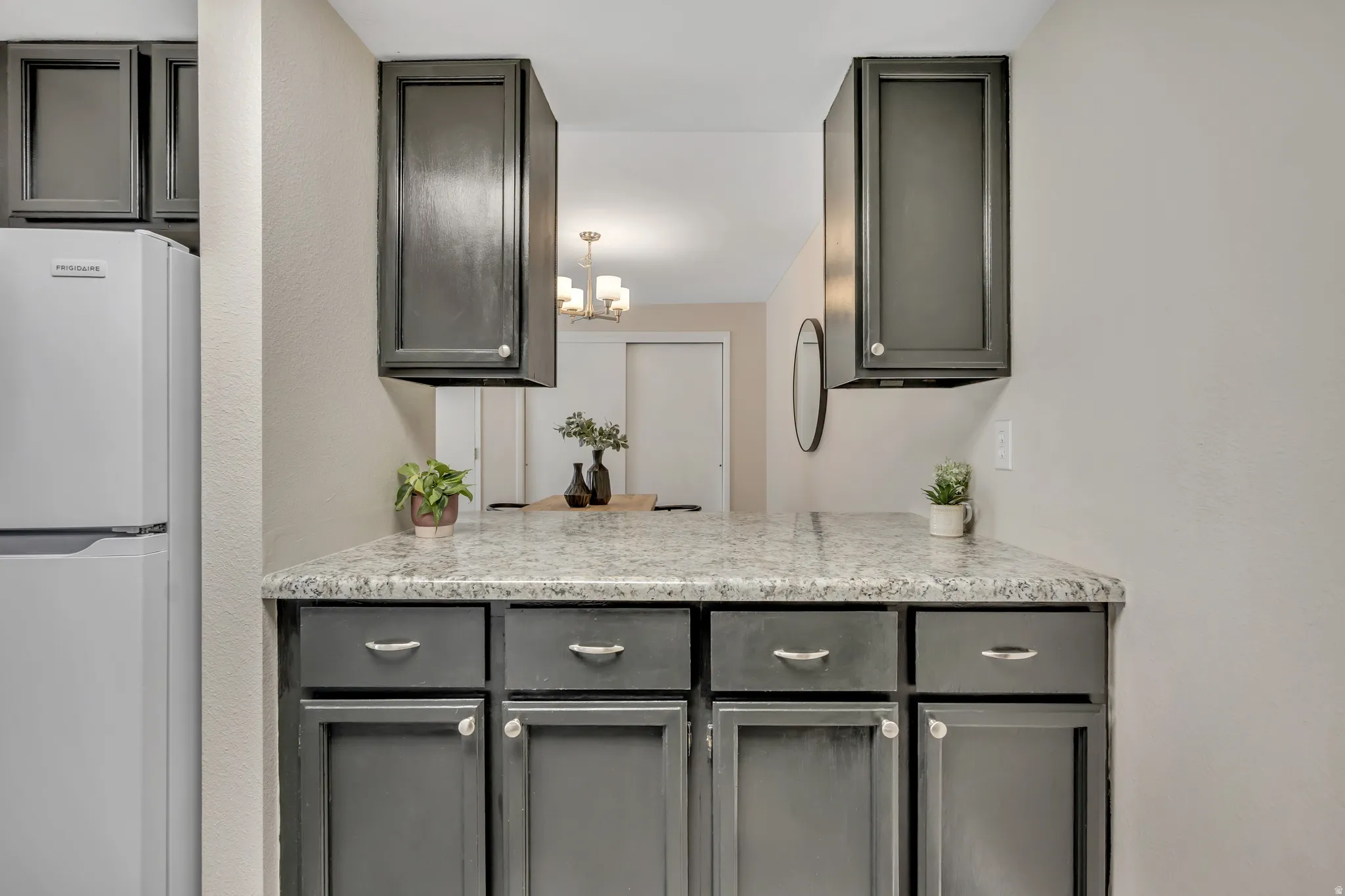 Kitchen looking into dining area and kitchen bar