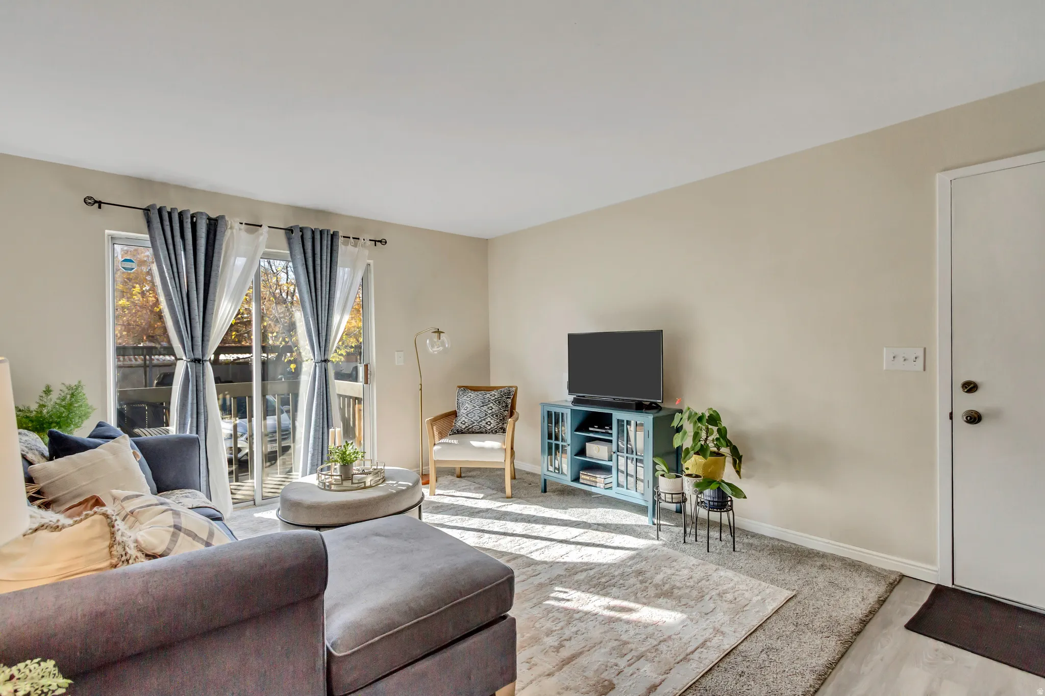 Living room/family room with sliding door that walks out to a balcony