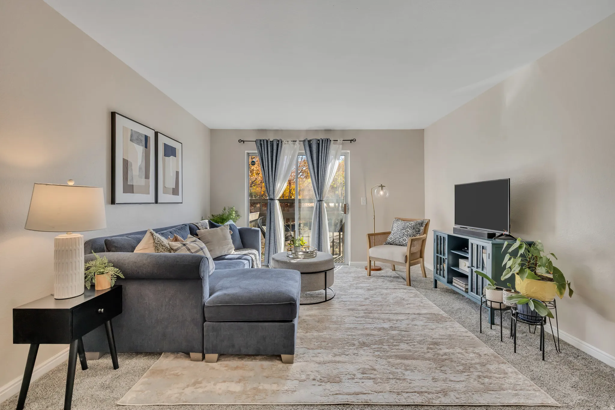 Living room/family room with sliding door that walks out to a balcony