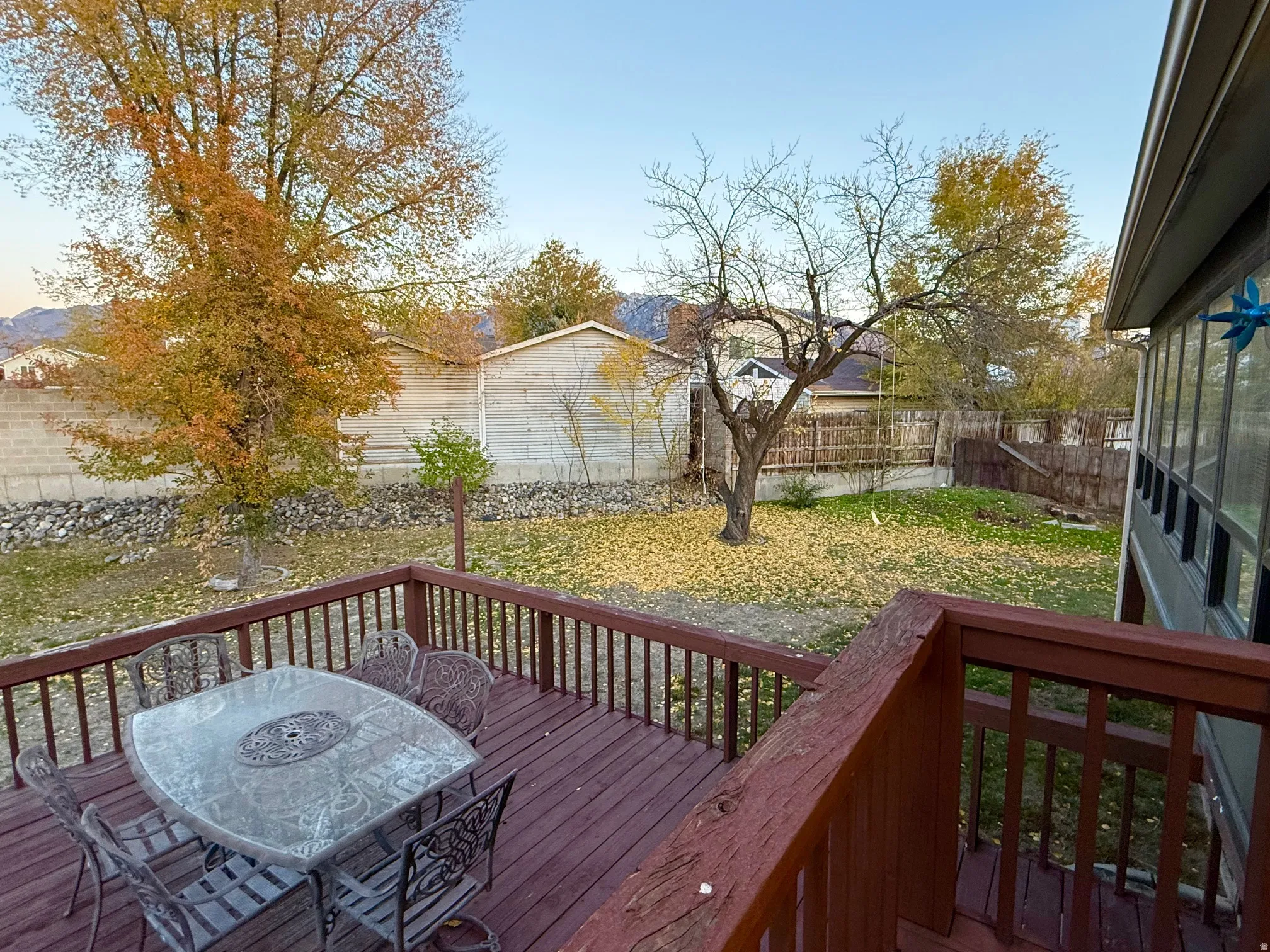 Wooden deck featuring a fenced backyard and outdoor dining area