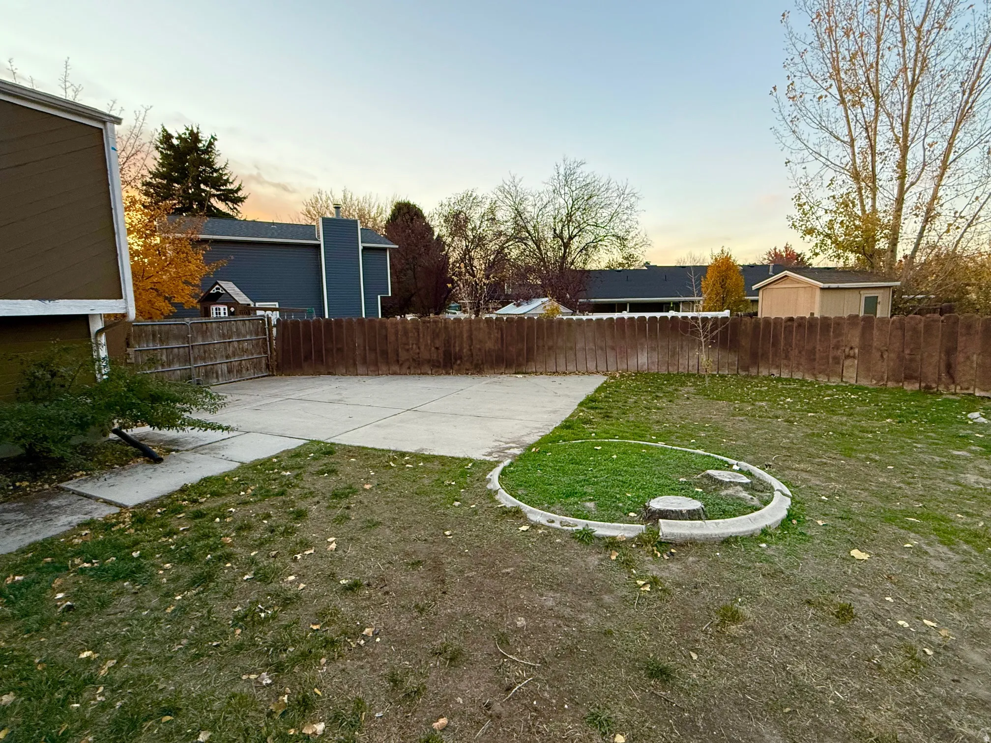 Yard at dusk featuring a fenced backyard