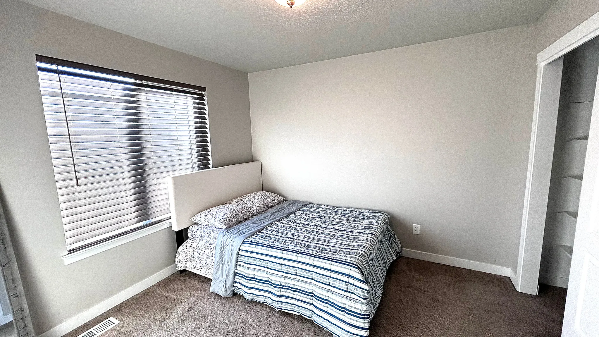 Bedroom with carpet and a textured ceiling
