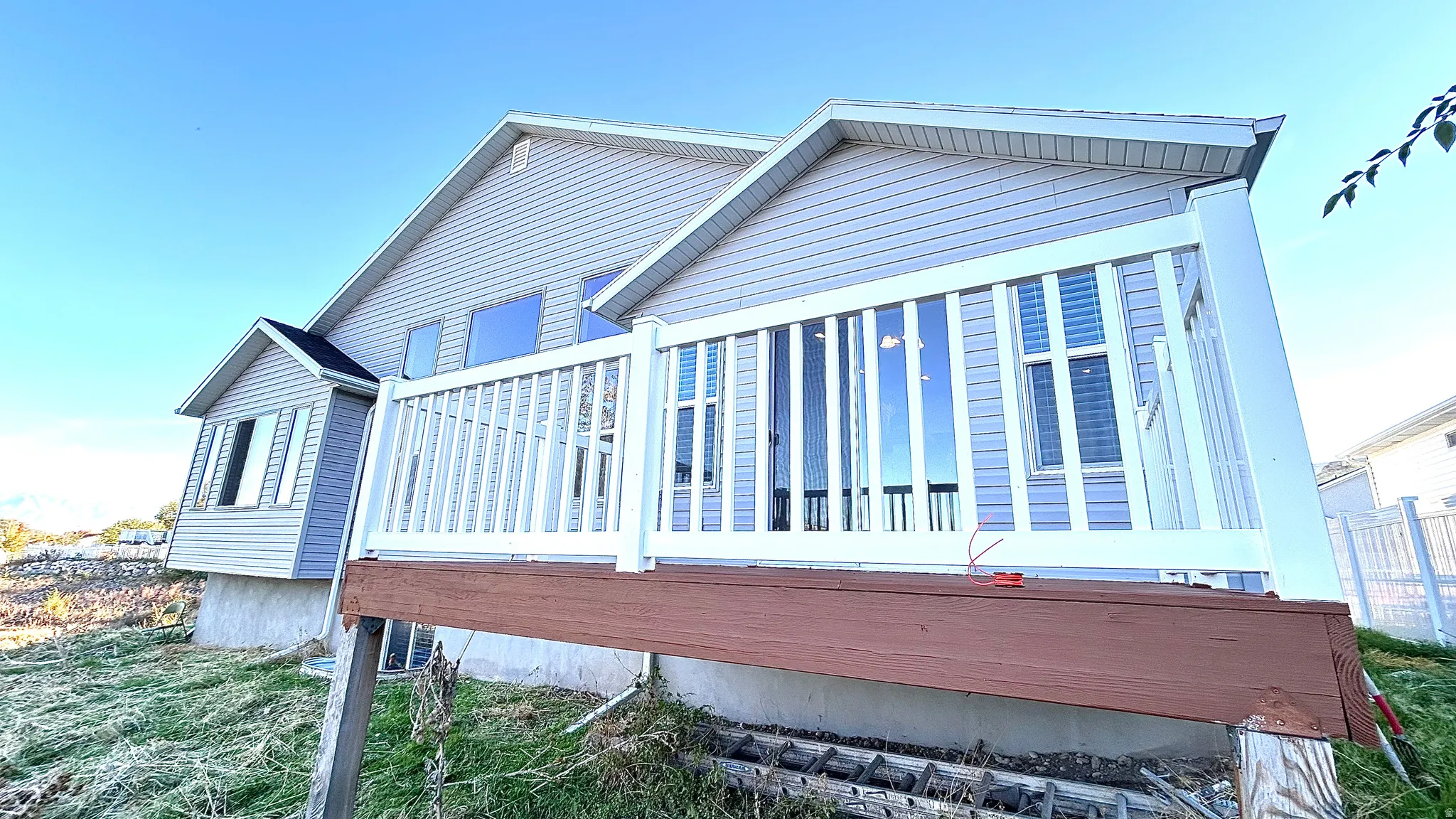 View of side of property featuring a wooden deck