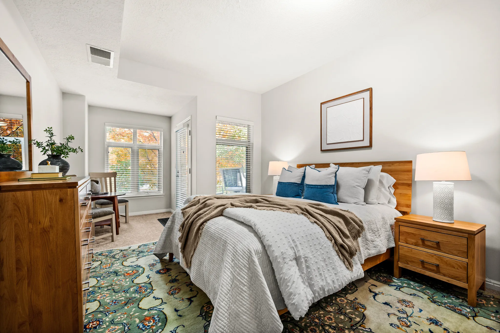 Large second-floor bedroom suite with walk-in closet and sitting area by the balcony door
