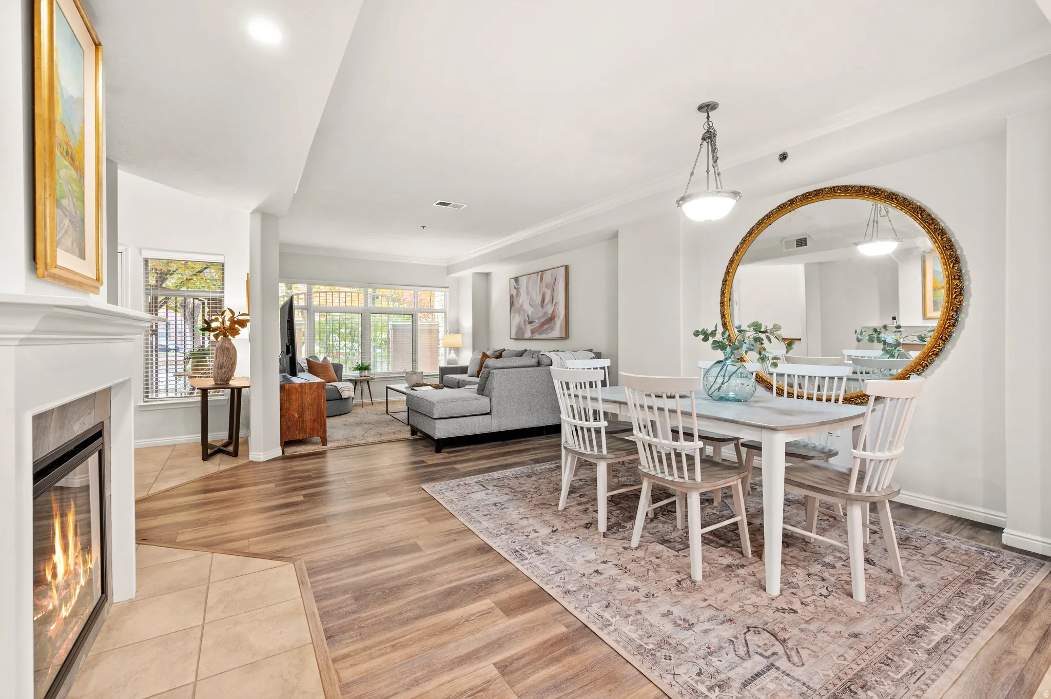 Dining area with a cozy fireplace, LVP flooring, and LED recessed lighting