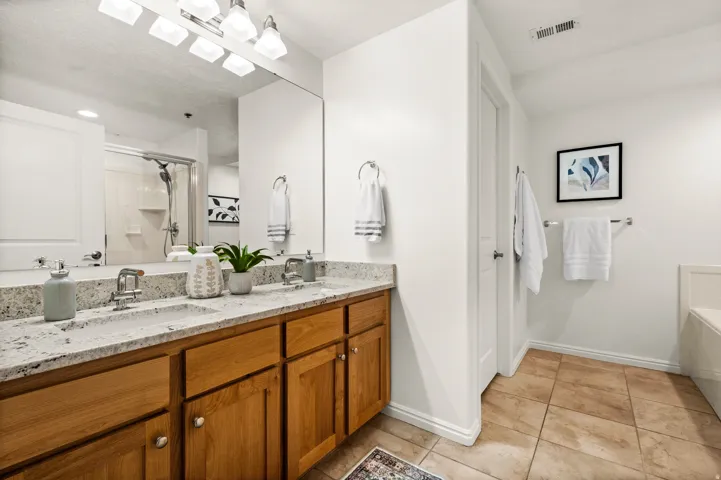 Primary bathroom with double sink vanity and separate shower and soaking tub
