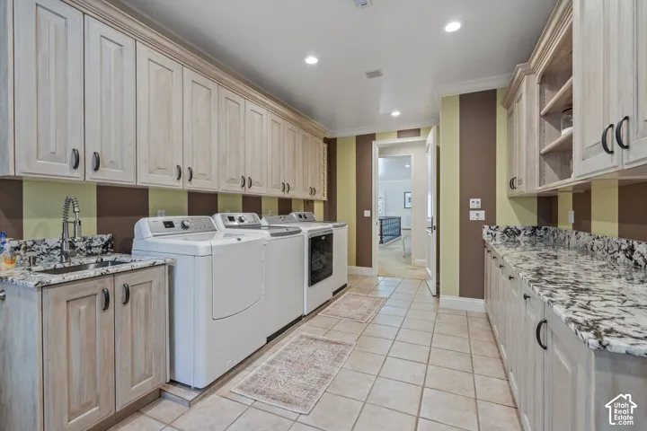 Laundry area with cabinet space, light tile patterned floors, recessed lighting, and washing machine and clothes dryer