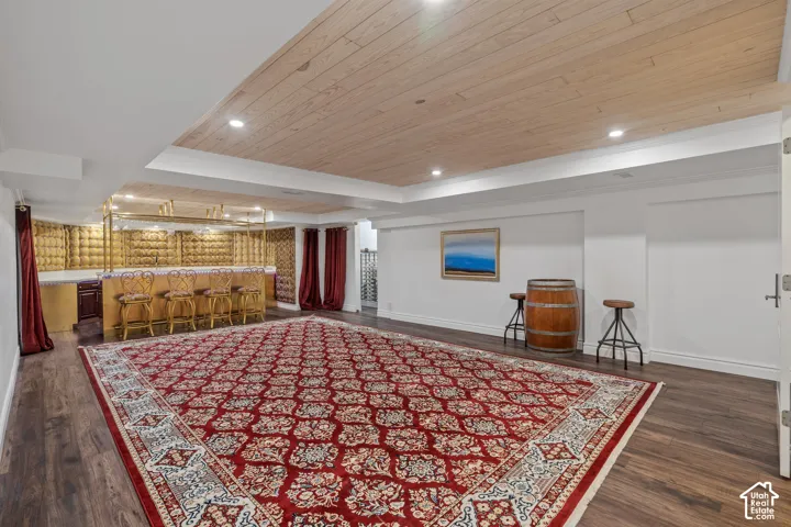 Living area featuring recessed lighting, wooden ceiling, dark wood finished floors, and wet bar
