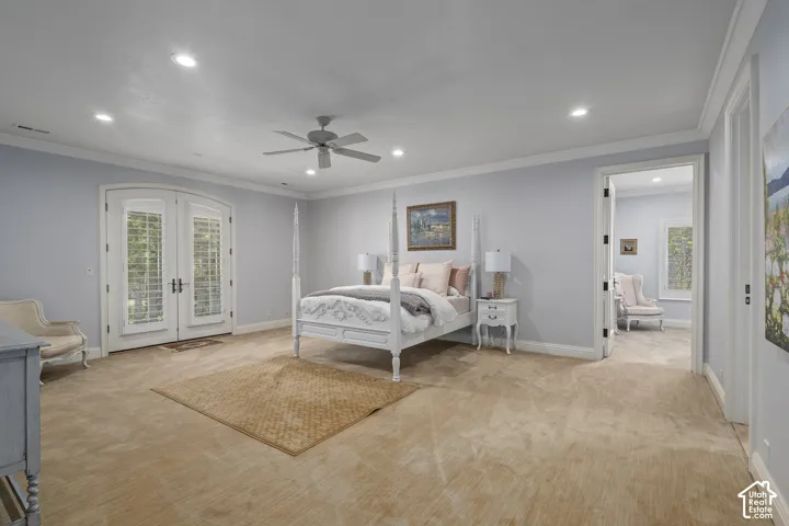 Bedroom with crown molding, access to outside, french doors, multiple windows, and carpet flooring