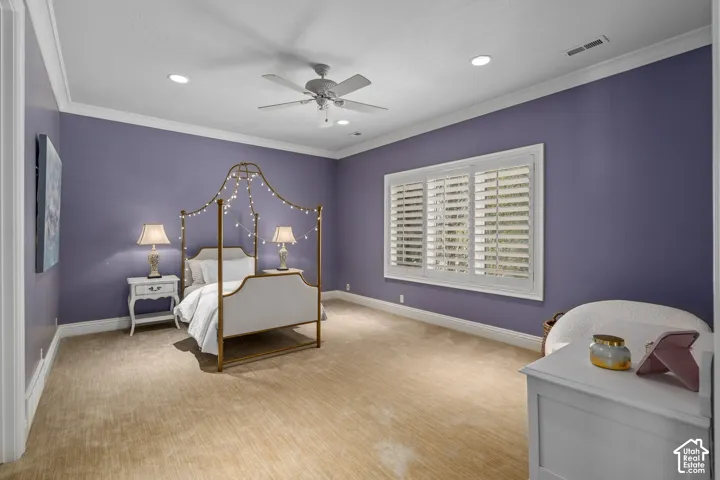 Bedroom with ornamental molding, ceiling fan, recessed lighting, and carpet