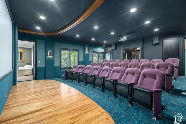 Home theater with recessed lighting, wood finished floors, and carpet floors