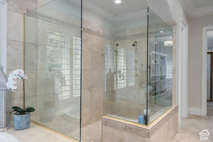Bathroom with a stall shower, ornamental molding, and recessed lighting