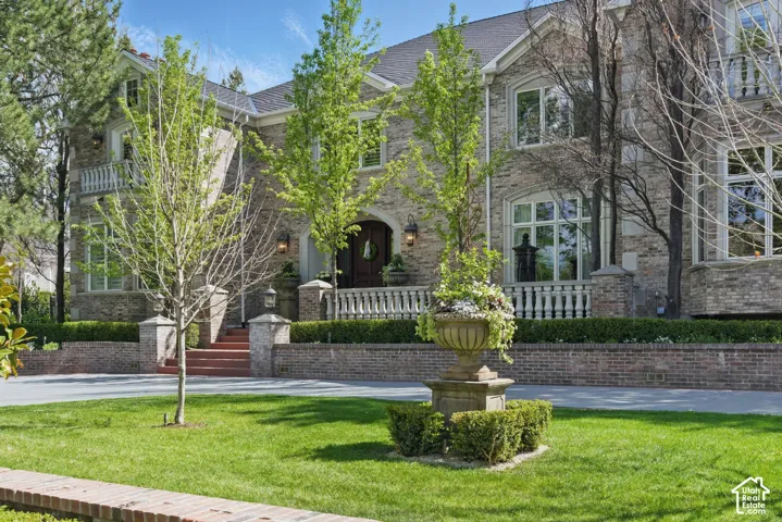 View of front of house featuring brick siding and a front yard