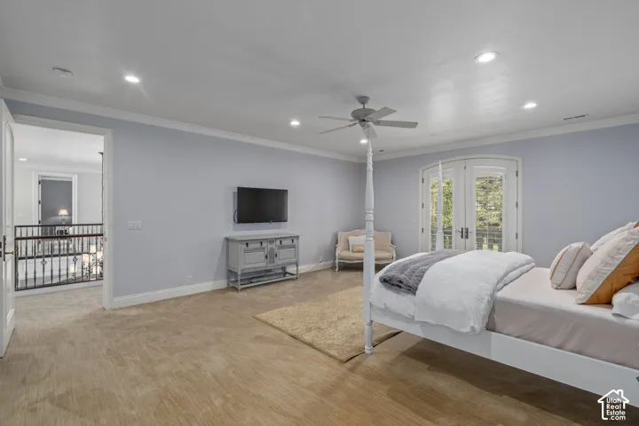 Bedroom with ornamental molding, light colored carpet, recessed lighting, a ceiling fan, and access to exterior