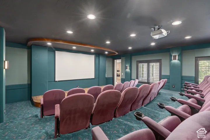 Carpeted home theater featuring a wainscoted wall and recessed lighting