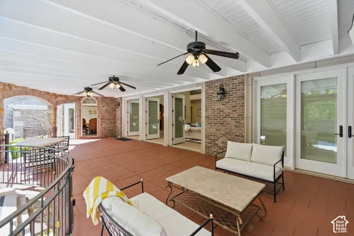 View of patio with ceiling fan, an outdoor living space, outdoor dining area, and french doors
