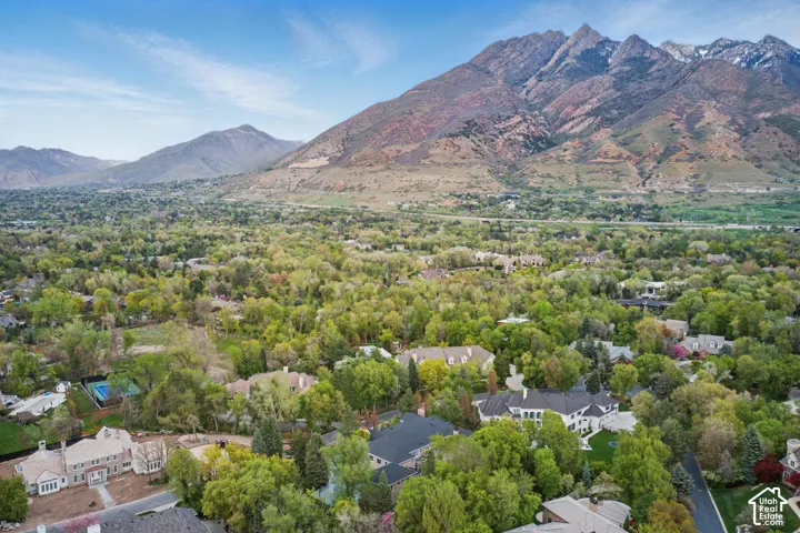 Aerial view of property's location with mountains and nearby suburban area