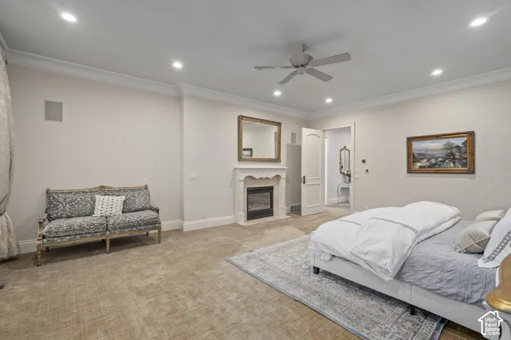 Bedroom featuring ornamental molding, carpet floors, recessed lighting, a fireplace with flush hearth, and a ceiling fan