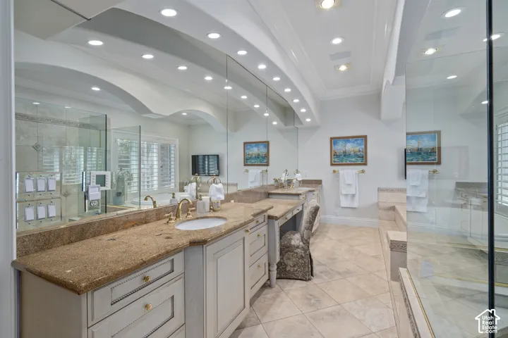 Full bath featuring ornamental molding, vanity, a stall shower, light tile patterned flooring, and recessed lighting