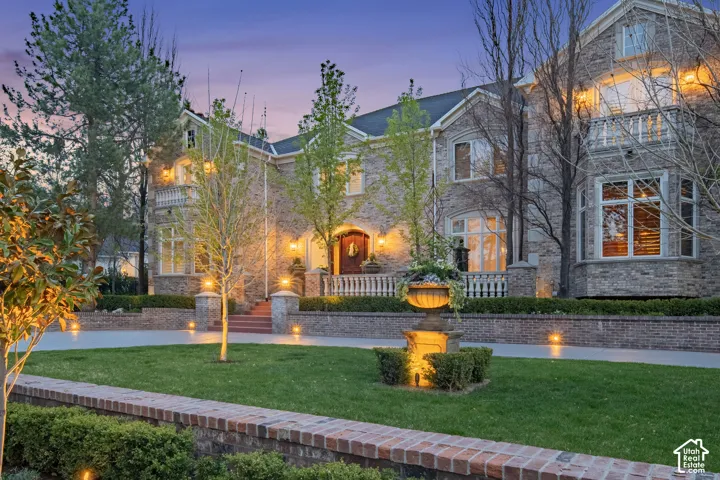 View of front of house featuring a front yard and brick siding