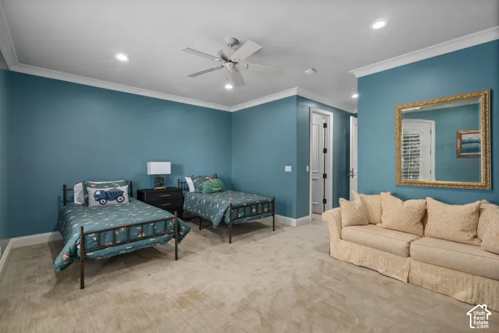 Carpeted bedroom featuring crown molding, recessed lighting, and a ceiling fan
