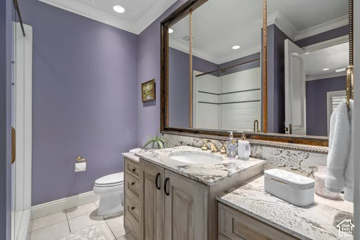 Full bathroom with crown molding, light tile patterned flooring, vanity, a shower, and recessed lighting