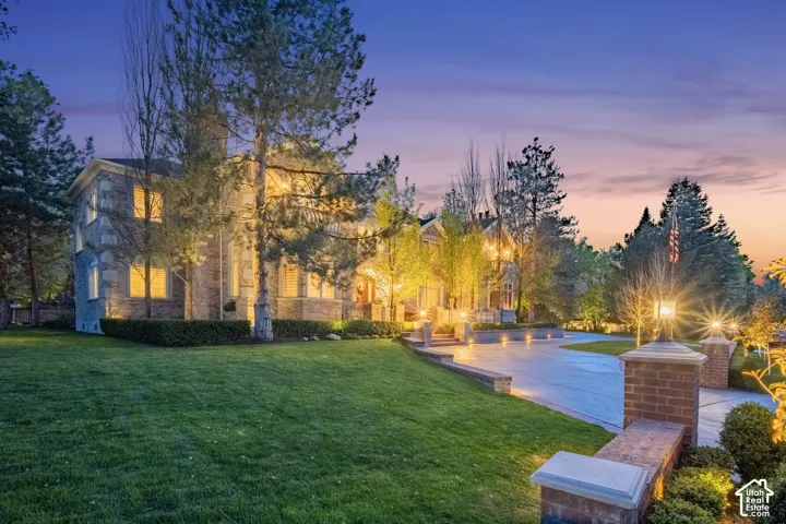 Surrounding community with a lawn and a patio area