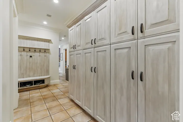 Mudroom featuring light tile patterned floors, recessed lighting, and ornamental molding