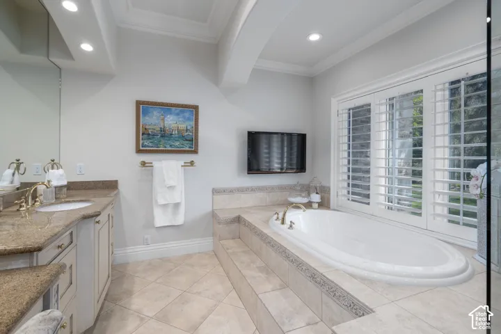 Bathroom featuring vanity, crown molding, a garden tub, recessed lighting, and beamed ceiling