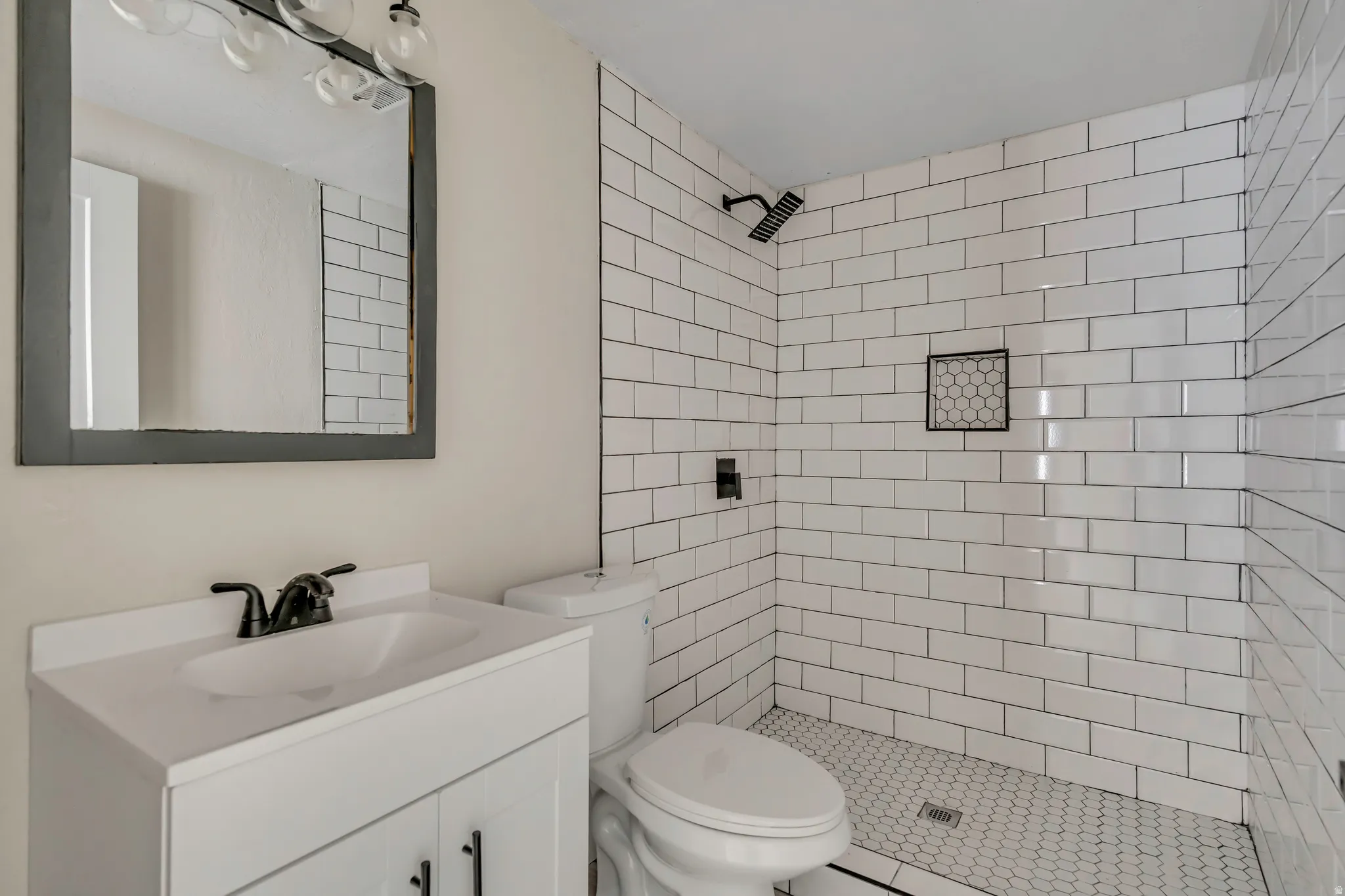 Full bathroom with vanity and a stall shower