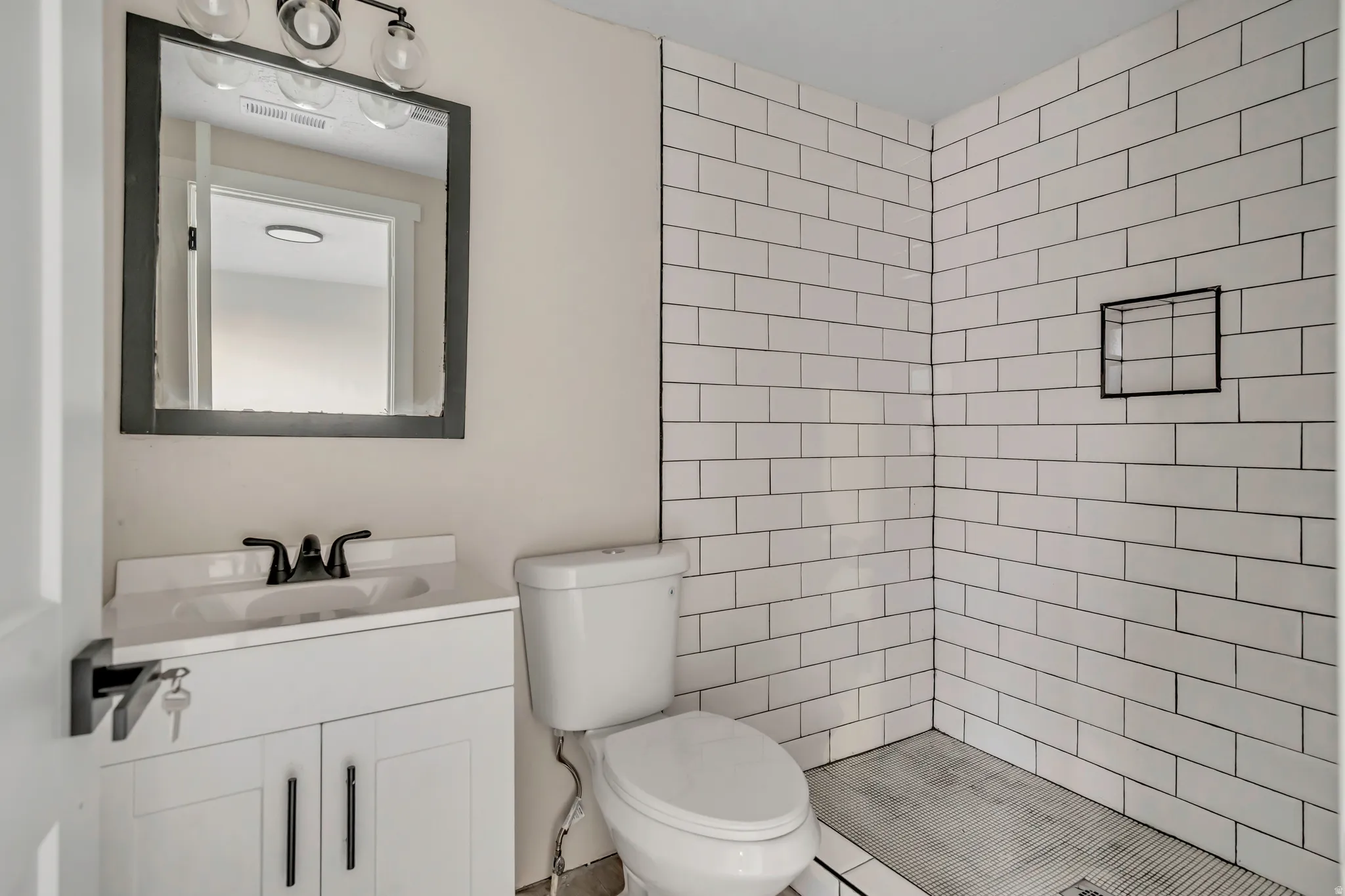 Bathroom featuring vanity and a stall shower