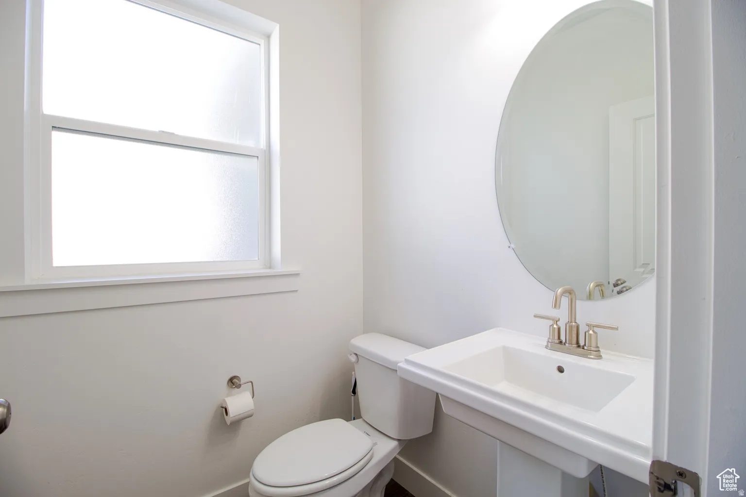 Bathroom featuring toilet and baseboards