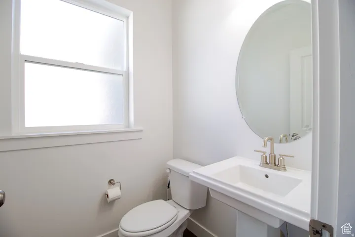 Bathroom featuring toilet and baseboards