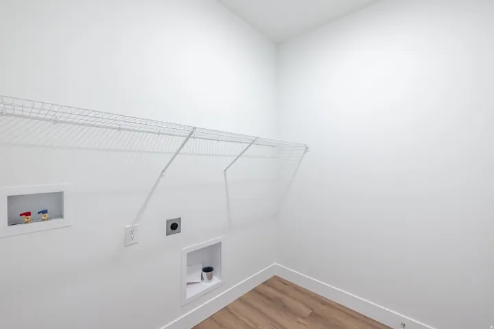 Laundry area with washer hookup, light wood finished floors, and hookup for an electric dryer