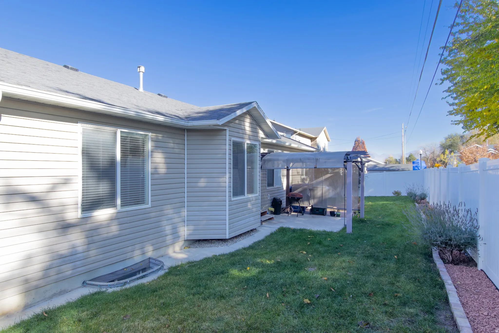 Fenced backyard featuring a patio and a pergola